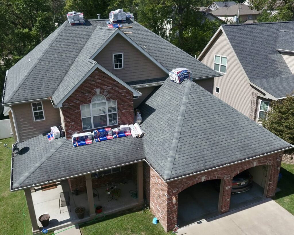 A Ballwin roofing contractor is installing new GAF Timberline shingles on a residential home.